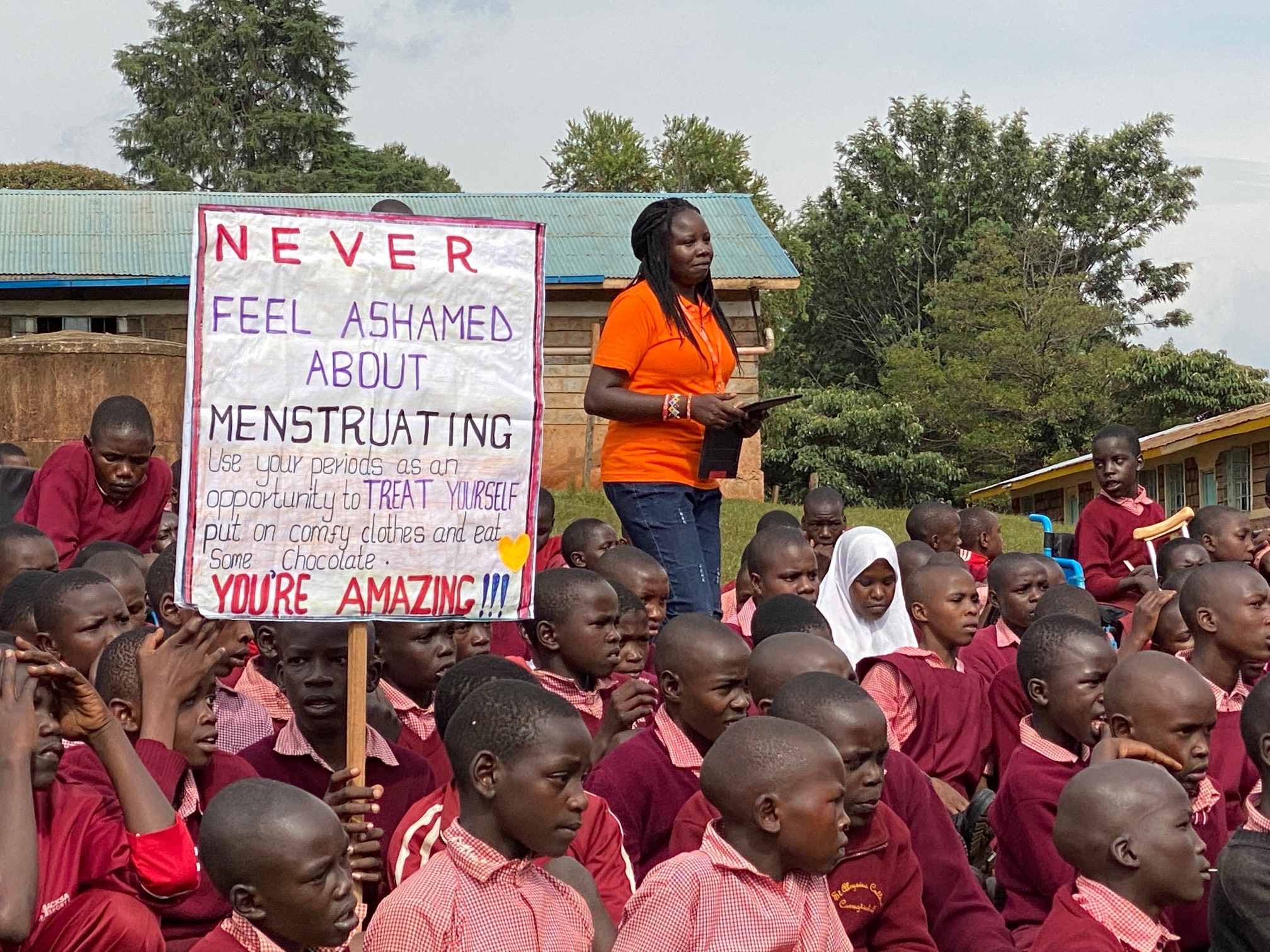 a group of children holding a sign that says never feel ashamed about retraining.