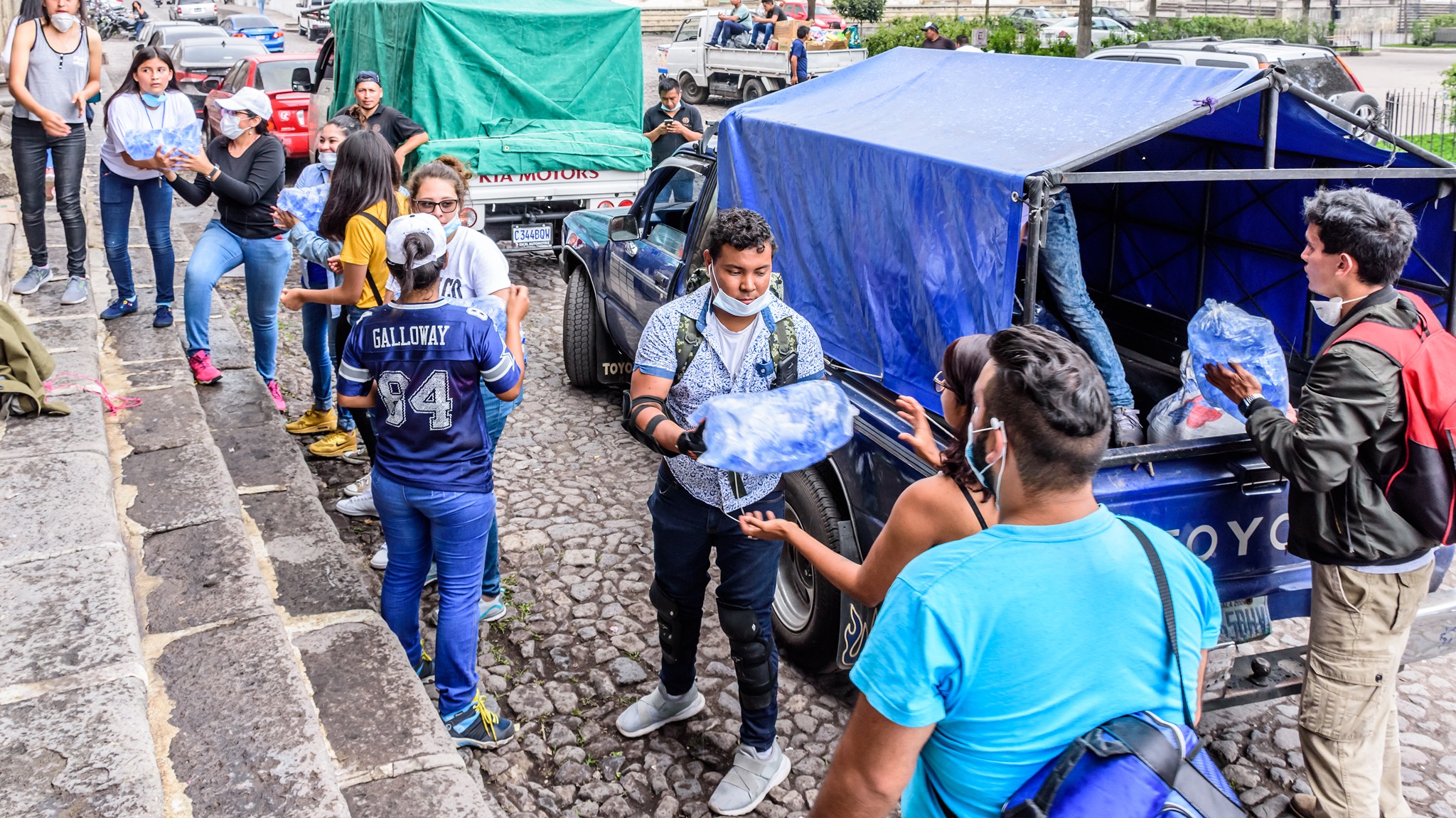 a group of people standing in front of a truck.