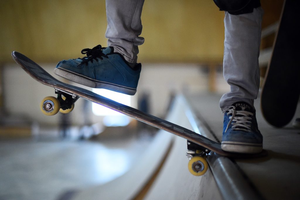 a person's feet on a skateboard.