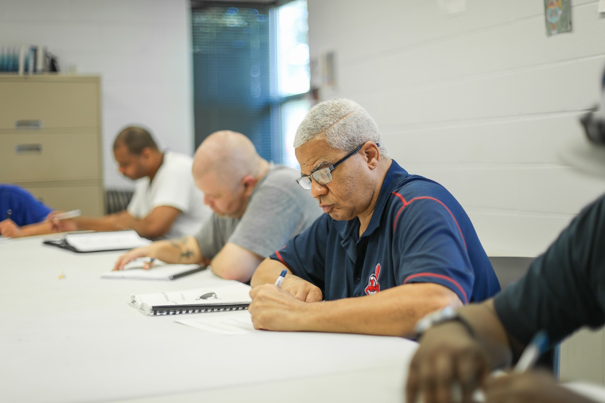 a group of men sitting at a table.