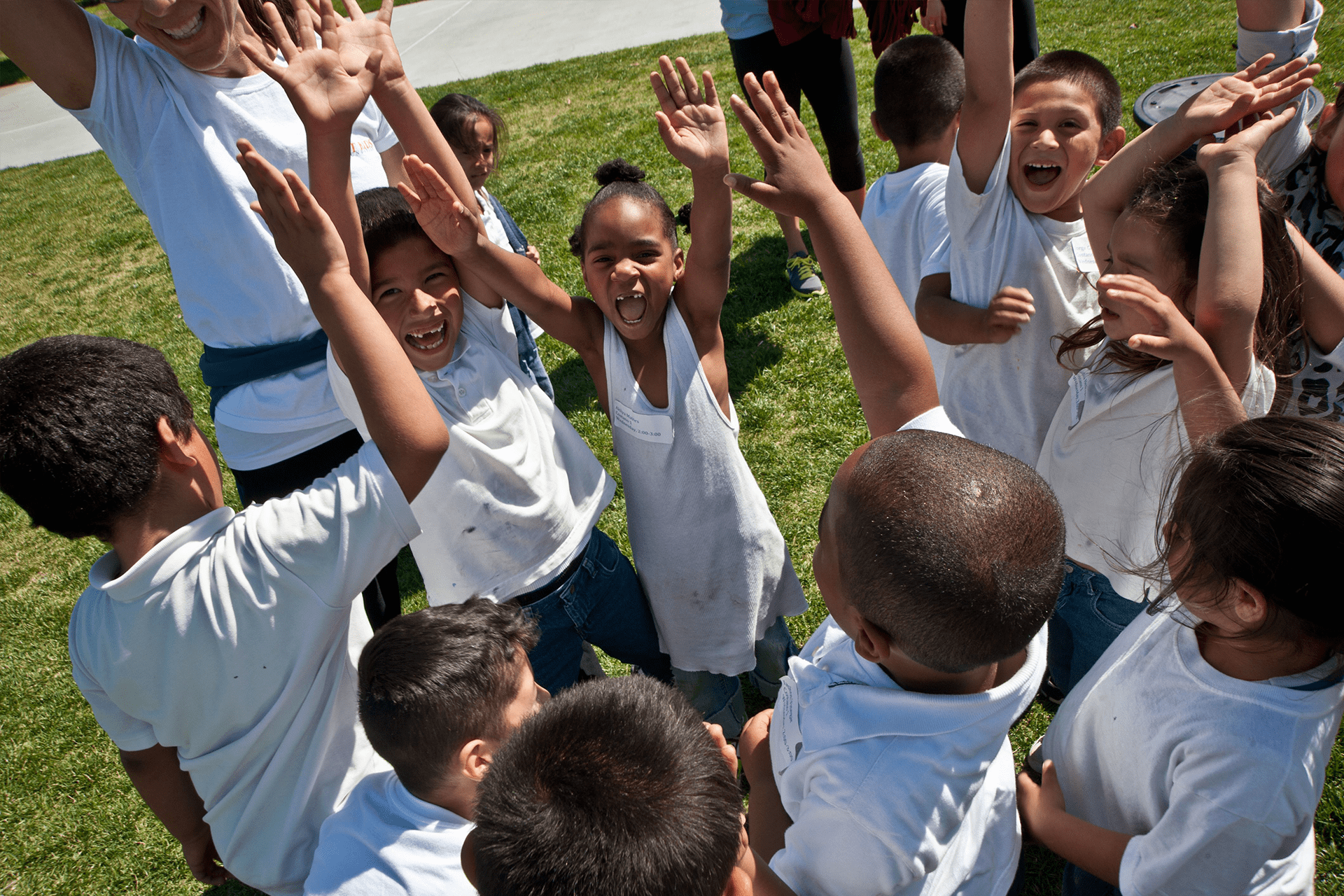 Kids in a circle cheering