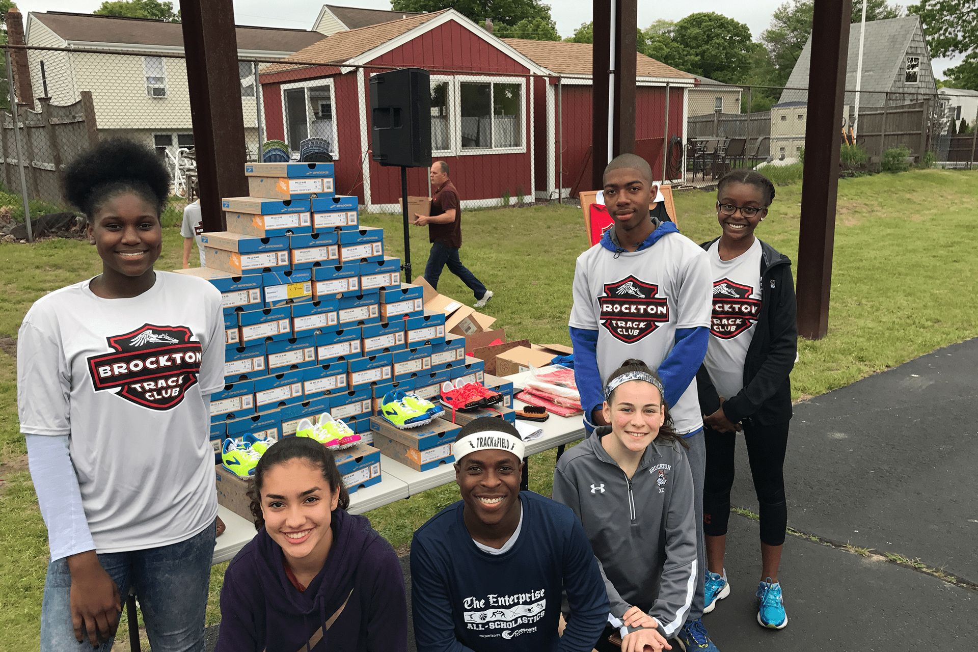 Teens of the Rockton track club with a table full of new track shoes