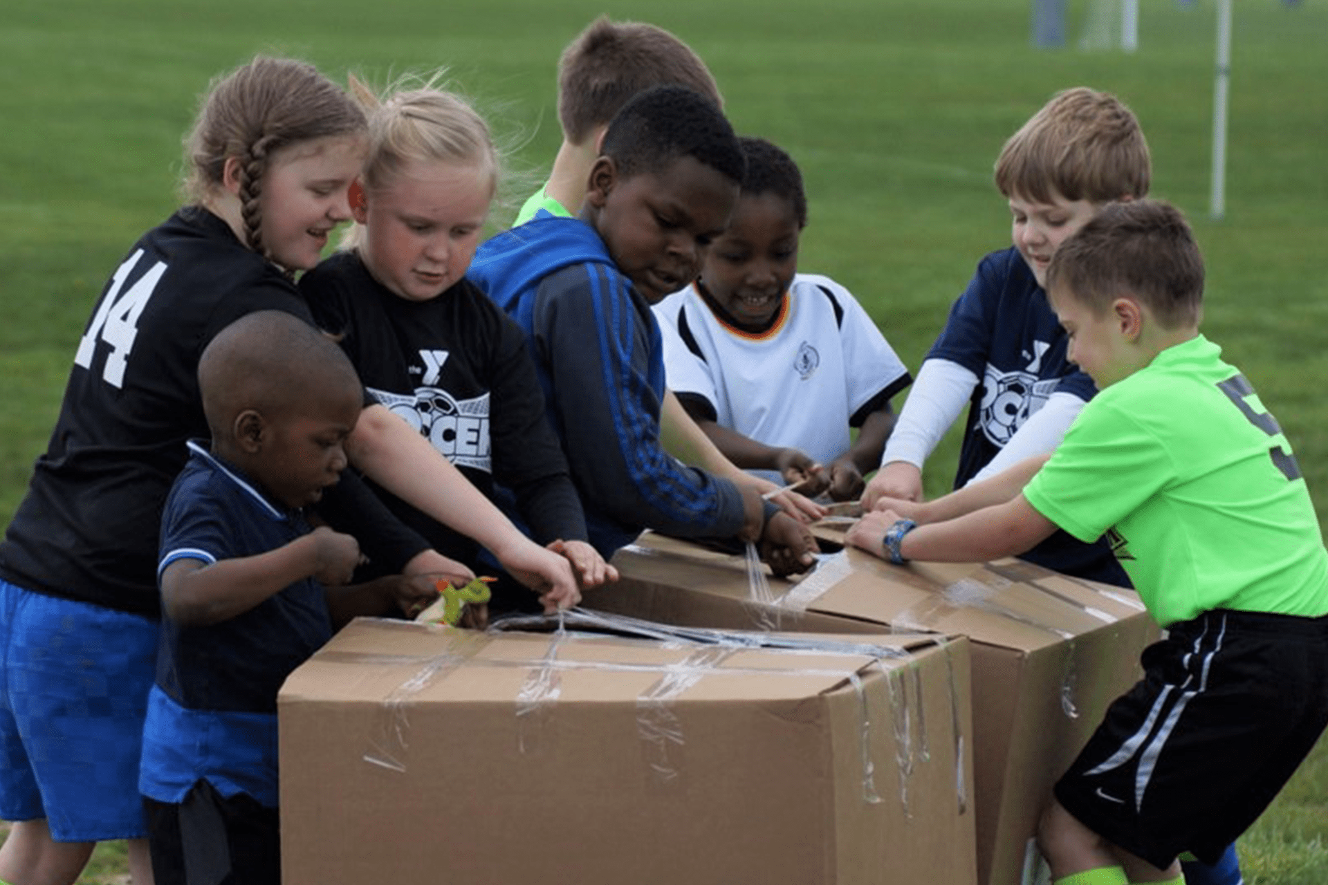 Kits ripping open two large boxes of new soccer gear