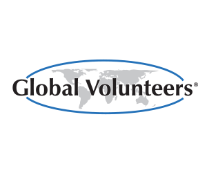 Logo of Global Volunteers featuring the text "Global Volunteers" with a world map in the background, encircled by a blue oval.