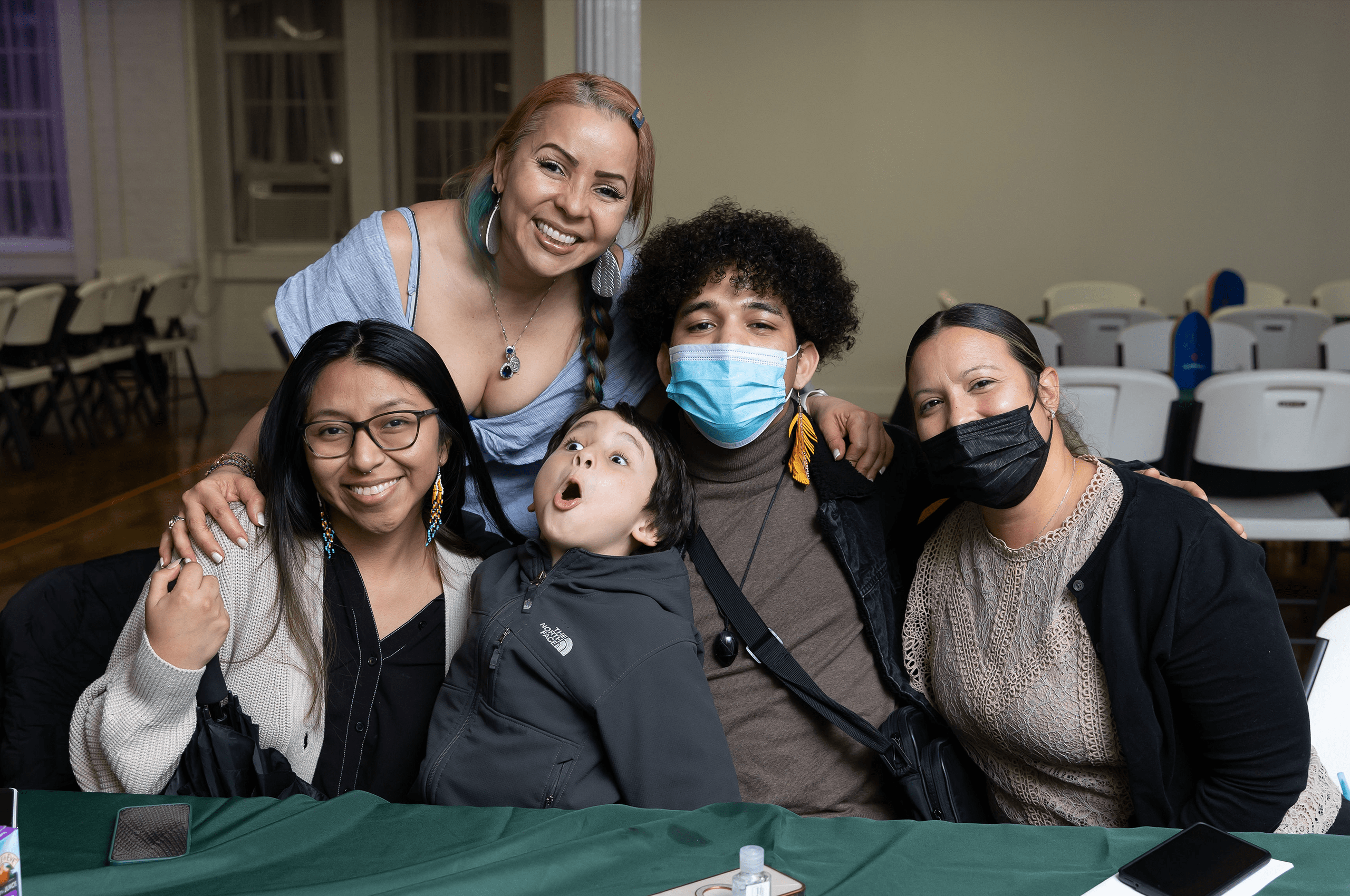 a group of people with face masks posing for a photo.
