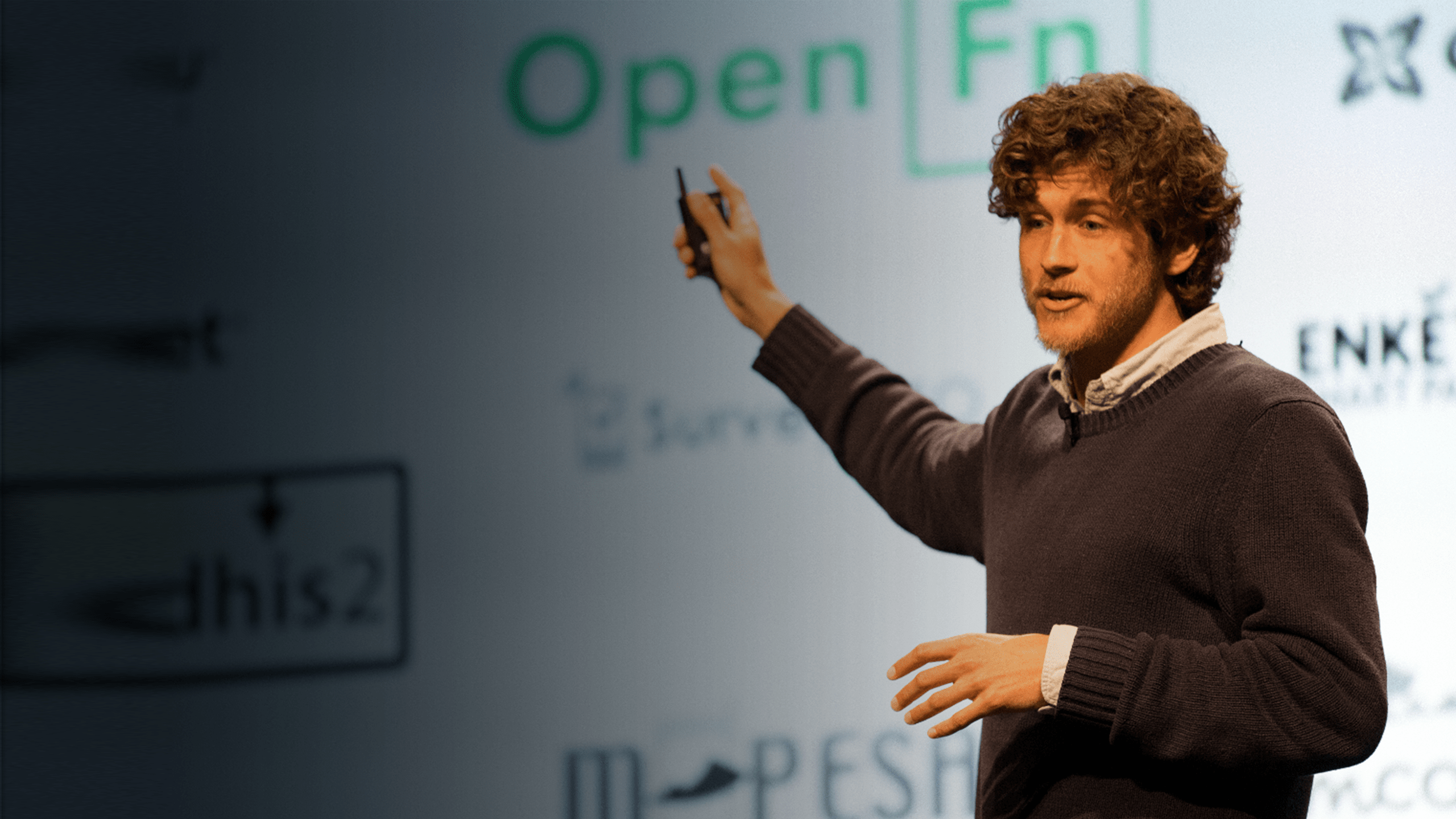 a man is standing in front of an open fn sign.