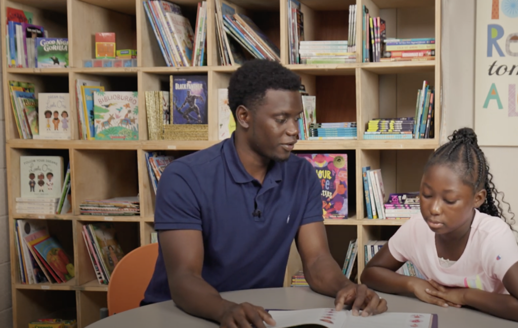 A man and a girl sitting at a table.